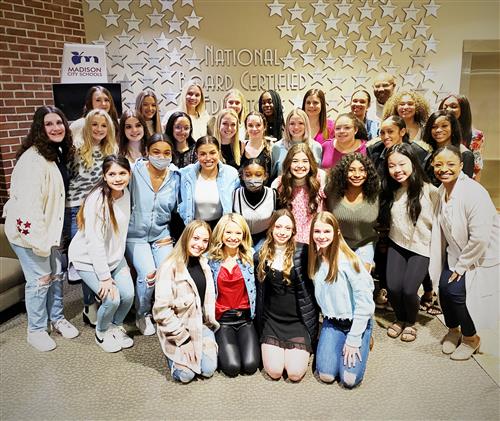 Group photo of Bob Jones cheerleaders in the lobby of the Madison City Schools Central Office